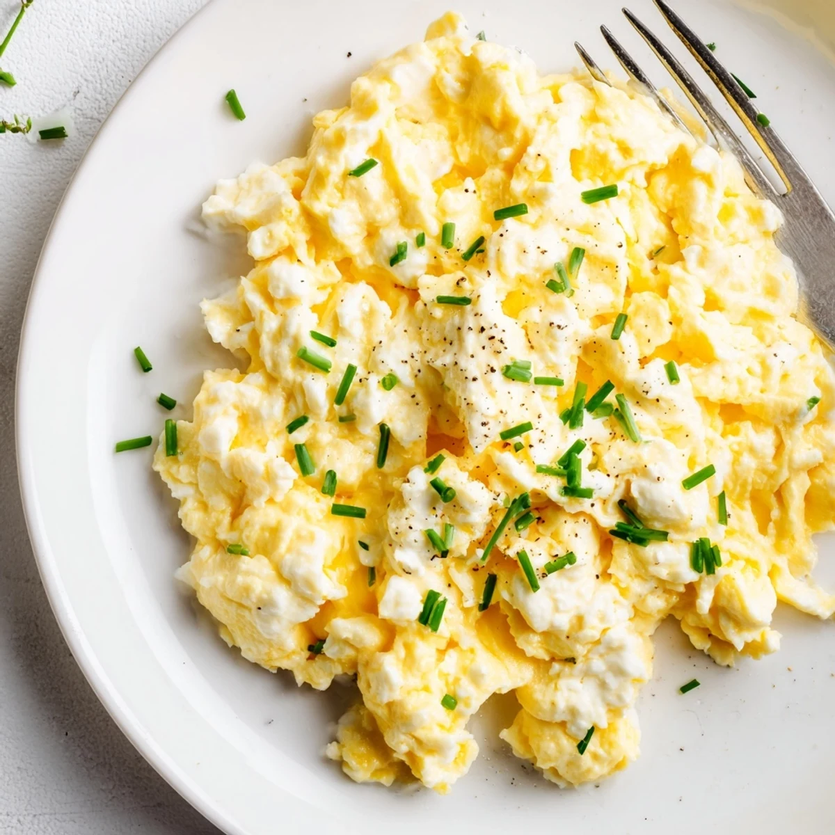 Cottage Cheese Scrambled Eggs with Chives, fluffy and creamy, plated with toast