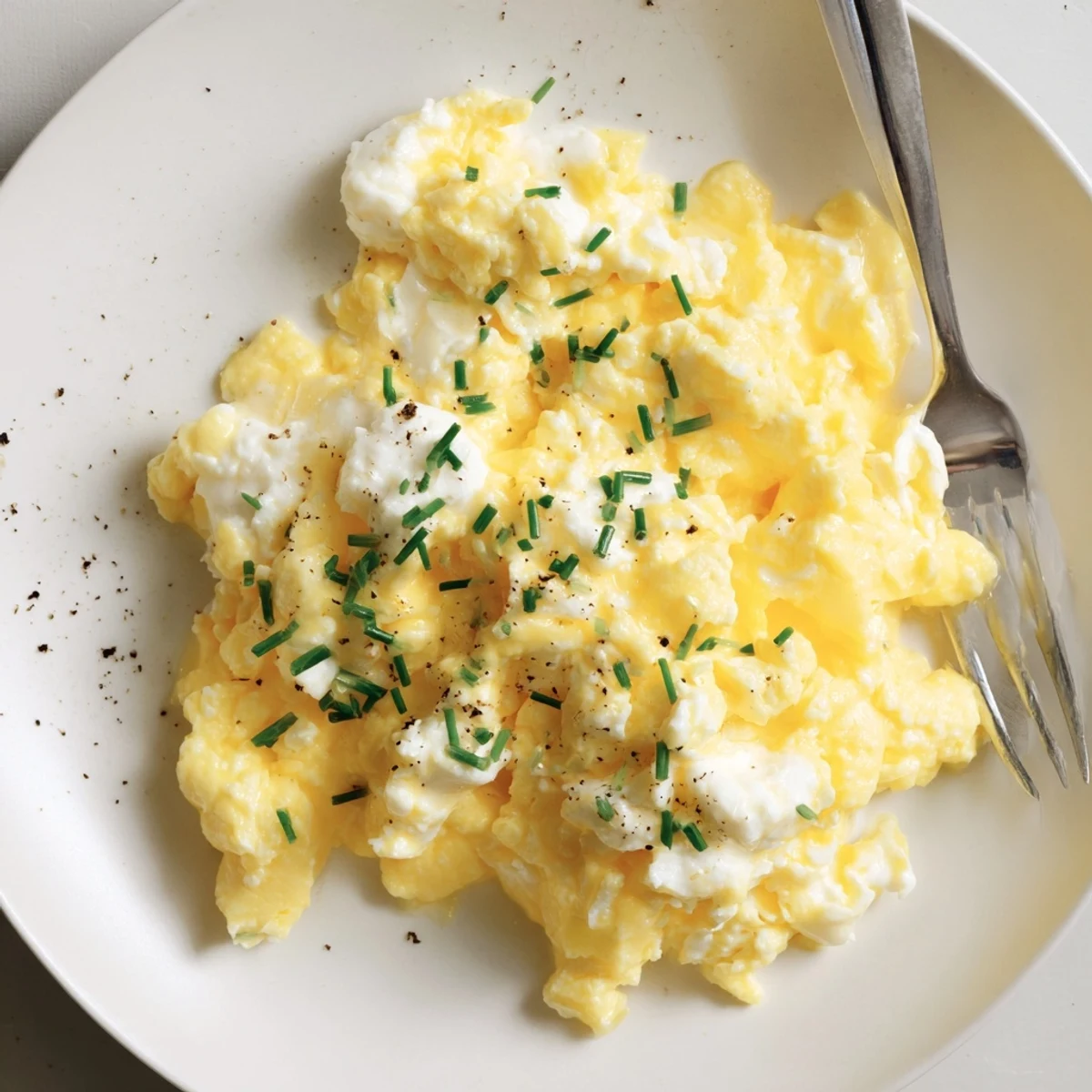Morning plate of Cottage Cheese Scrambled Eggs with Chives, garnished, ready to serve
