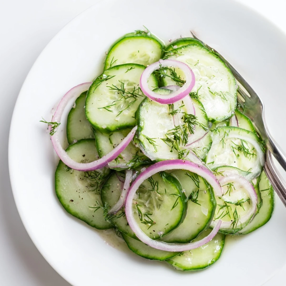 Thinly sliced Cucumber Salad on wooden board, ideal alongside grilled chicken.