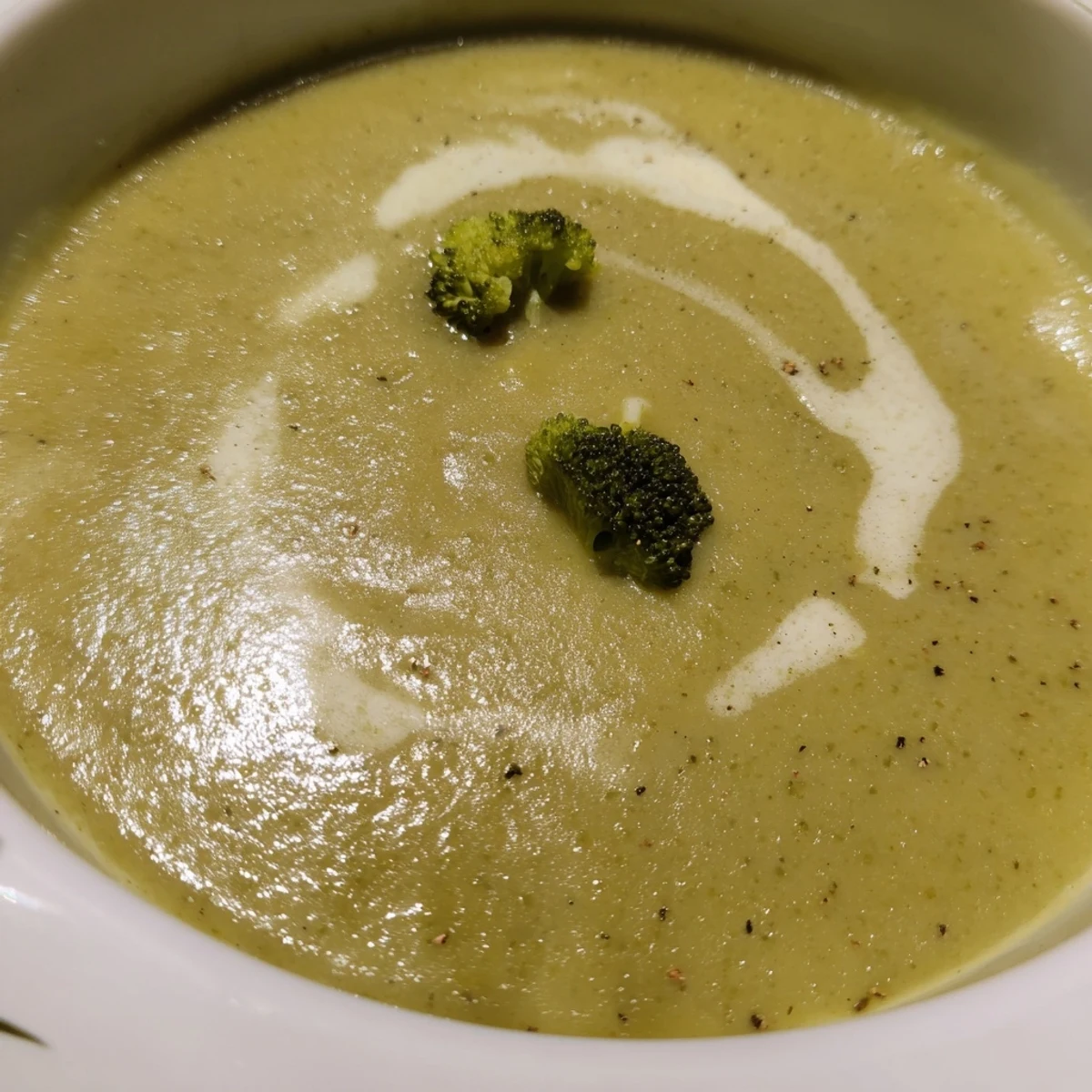 Creamy Broccoli Soup steaming in bowl, hints of nutmeg and olive oil.