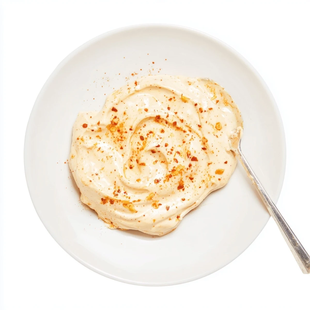 Rich smoky garlic sauce dollopped onto a grilled burger showcasing its thick velvety texture