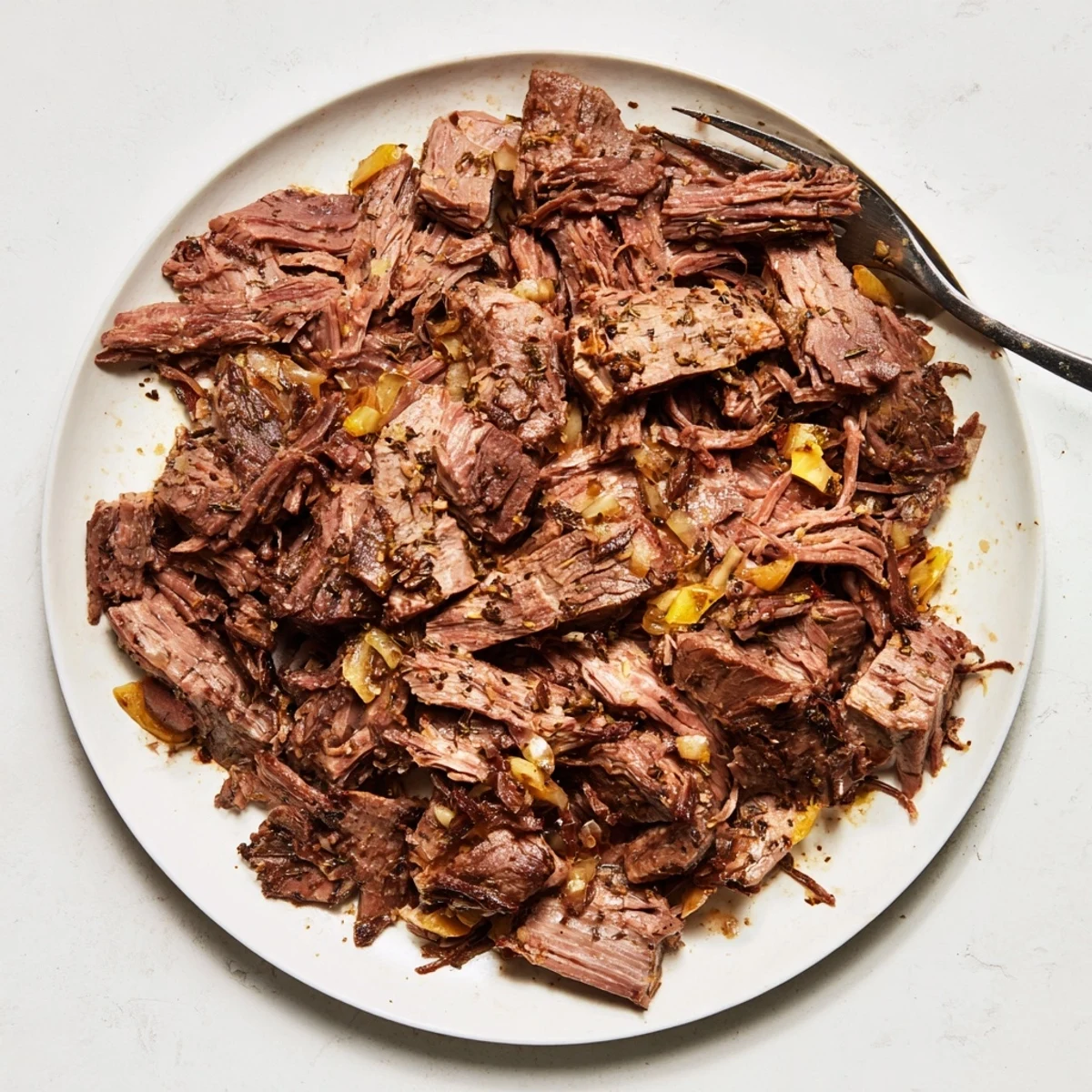 Tender slow cooker beef barbacoa shredded into juicy spicy chunks perfect for street tacos