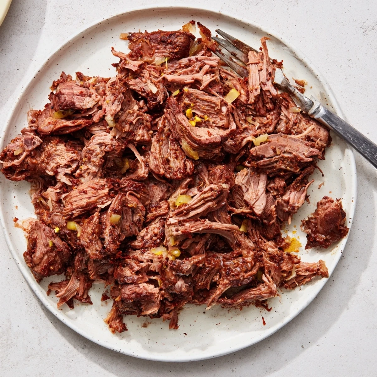 Savory Mexican-style slow cooker beef barbacoa piled high in a bowl with fresh cilantro