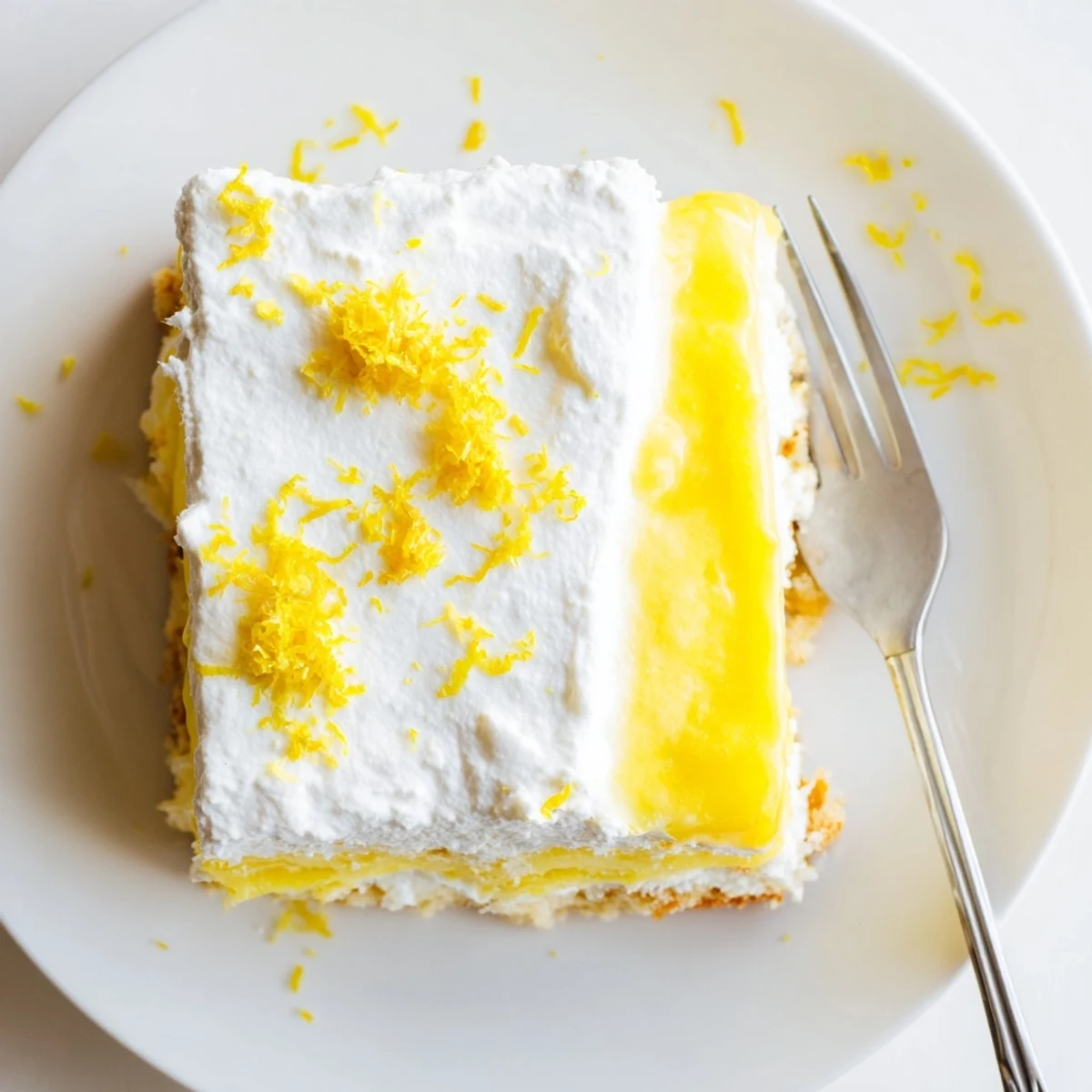 Golden buttery crust layered with tangy lemon pudding and cream cheese filling topped with whipped cream