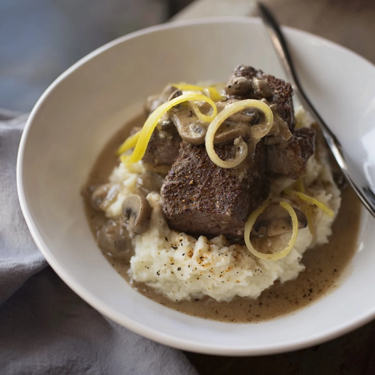 Country Style Smothered Cube Steak Recipe with silky onion-mushroom gravy over mashed potatoes