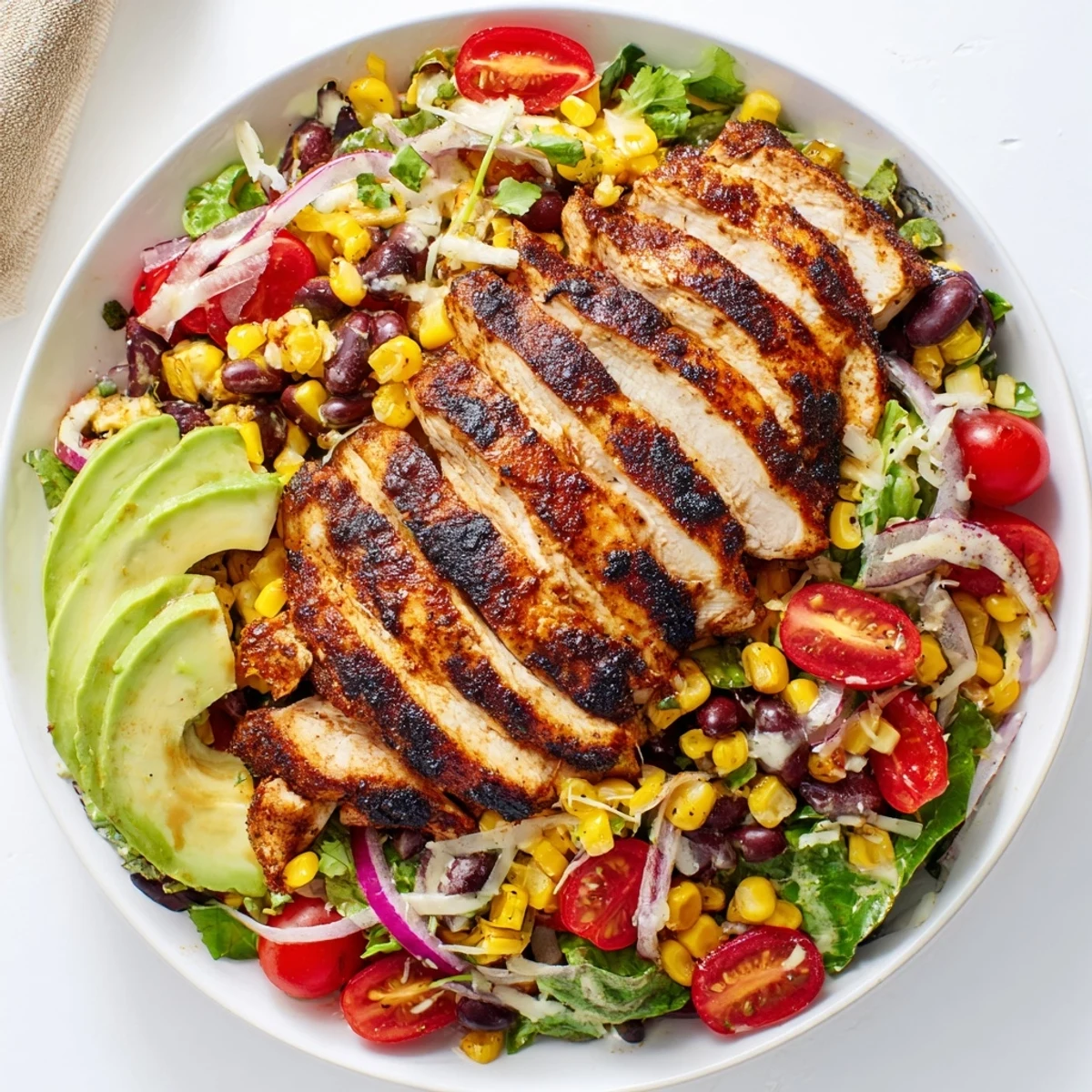Sliced grilled chicken crowns a Southwestern Chicken Salad with zesty lime dressing