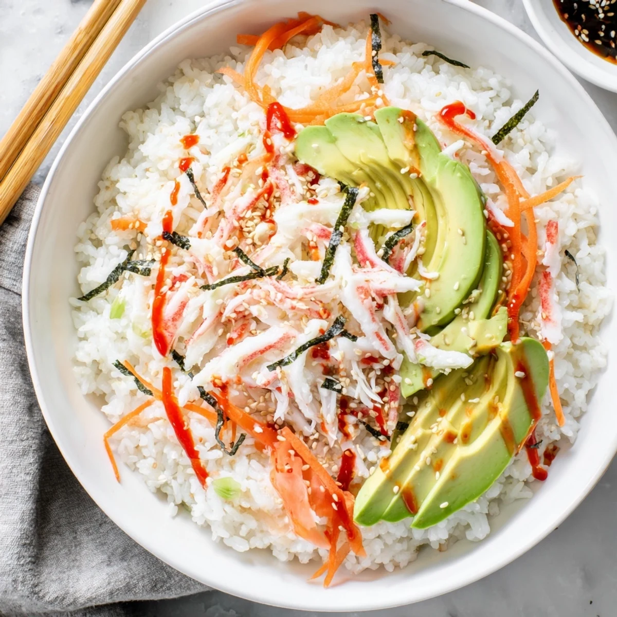 Deconstructed California Roll Sushi Bowls on seasoned rice, drizzled spicy mayo, pickled ginger.