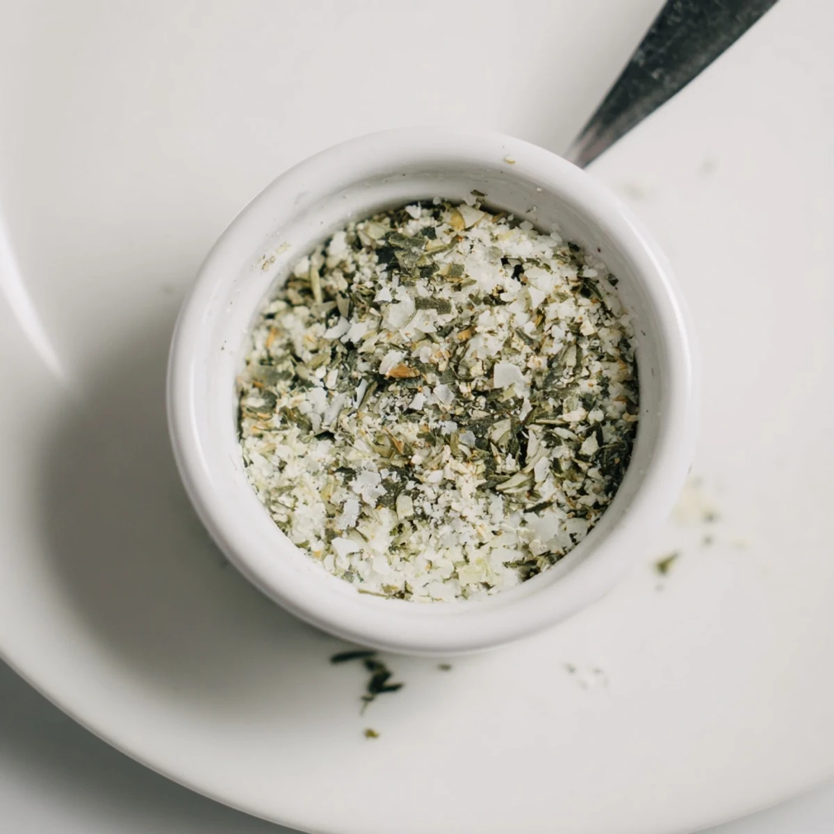 Glass jar of Dehydrated Tzatziki Seasoning Mix with fragrant dried herbs