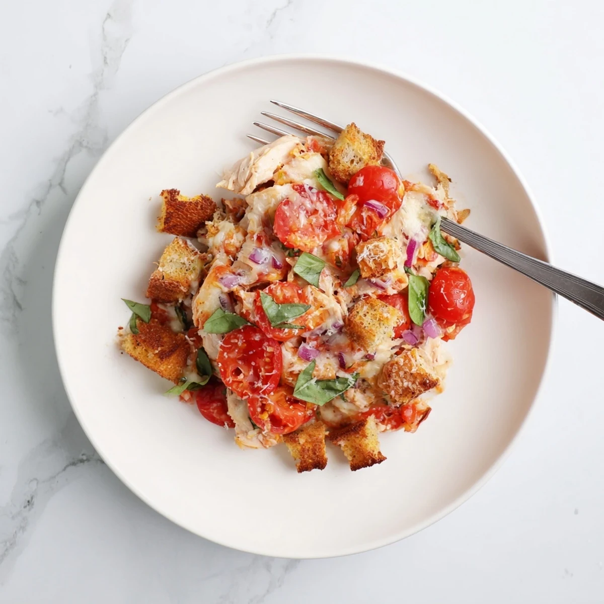 Golden bubbly chicken bruschetta casserole fresh from the oven with melted mozzarella