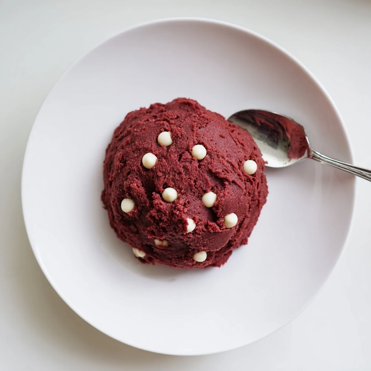 Rich edible red velvet cookie dough topped with melty white chocolate chip morsels