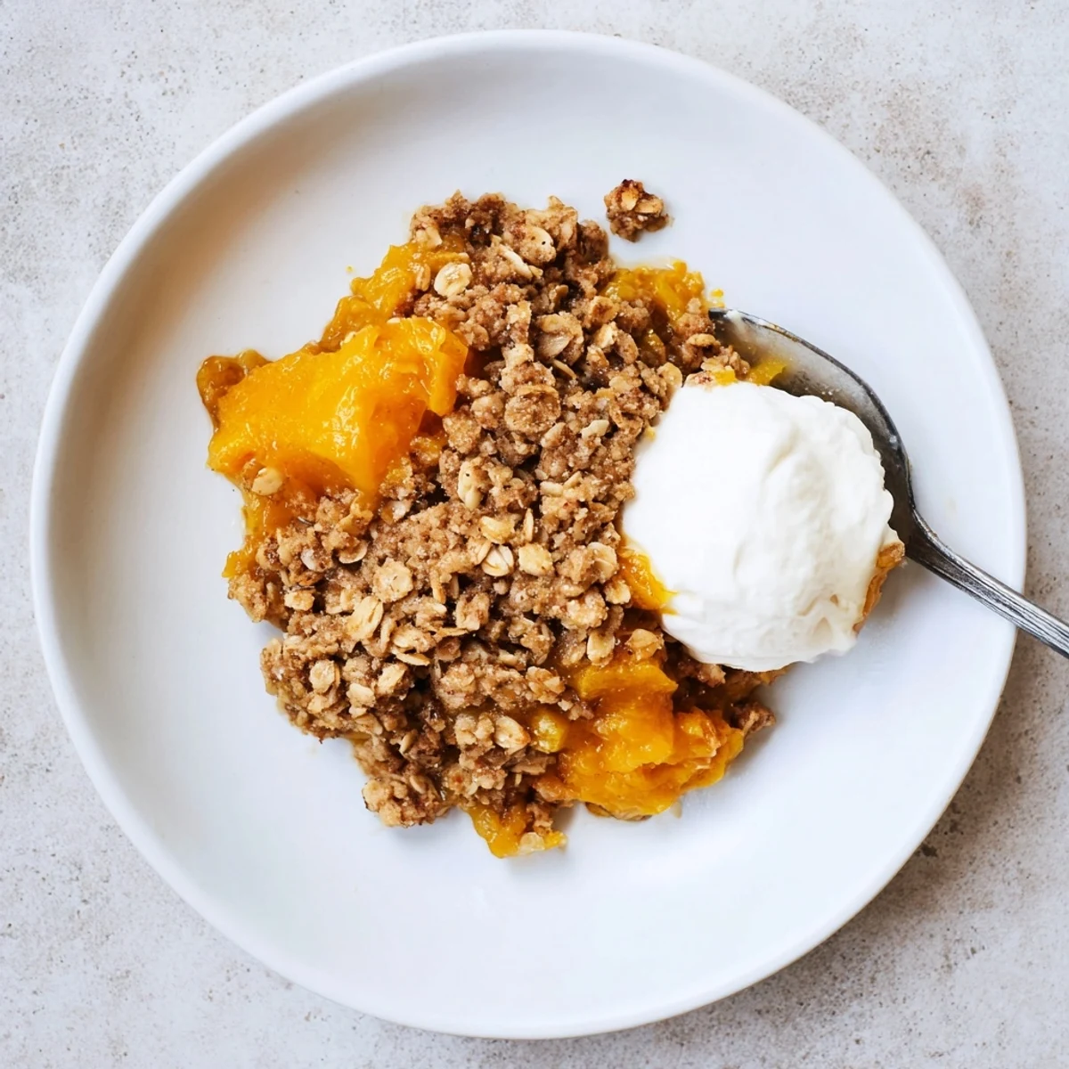 Spiced pumpkin pie crisp topped with buttery brown sugar oat crumble close-up