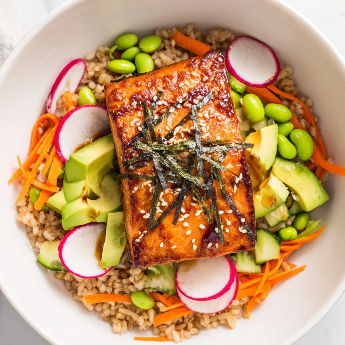 Tender miso-glazed salmon nestled over brown rice with colorful fresh vegetables