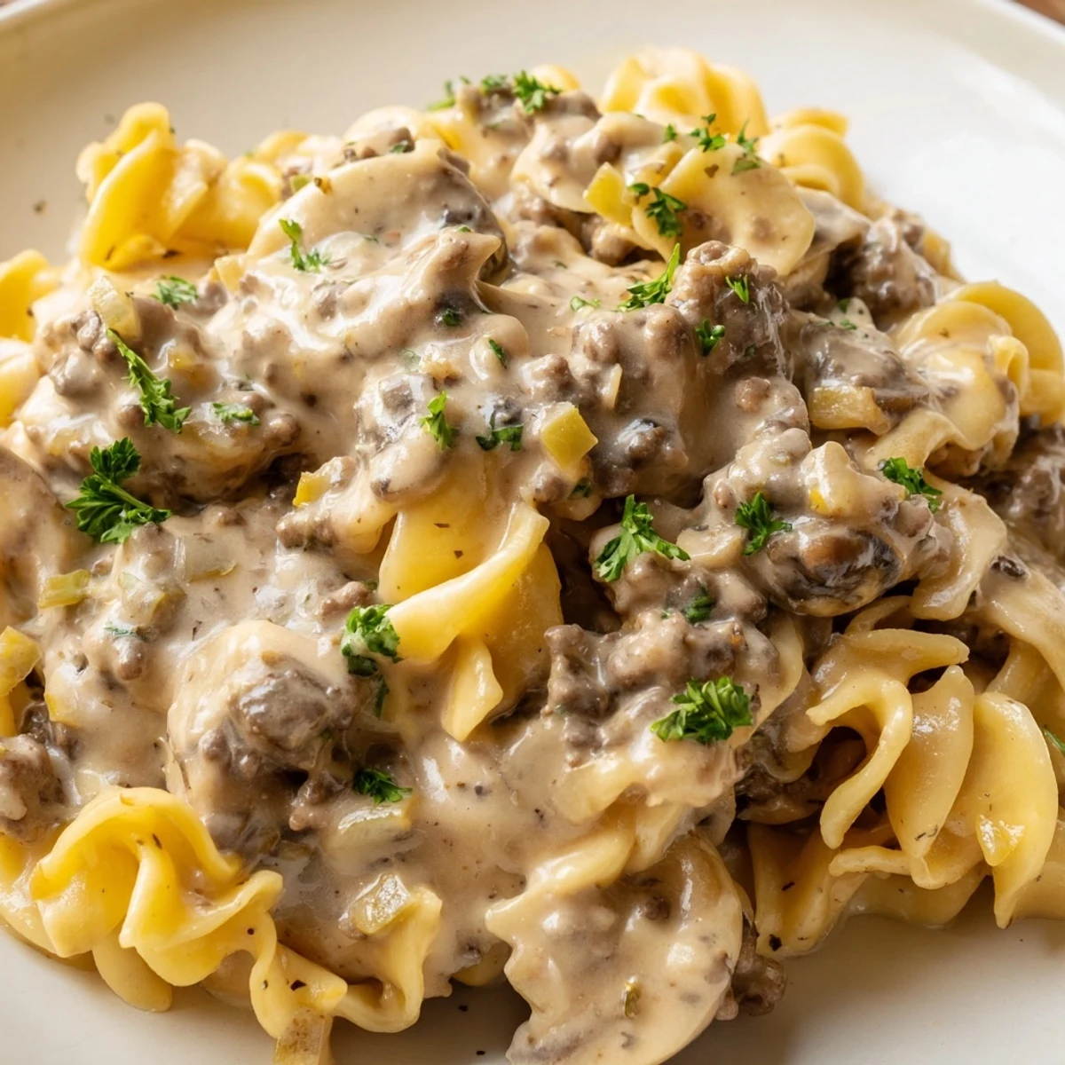 Hearty hamburger stroganoff in a rich sour cream mushroom sauce coating golden egg noodles