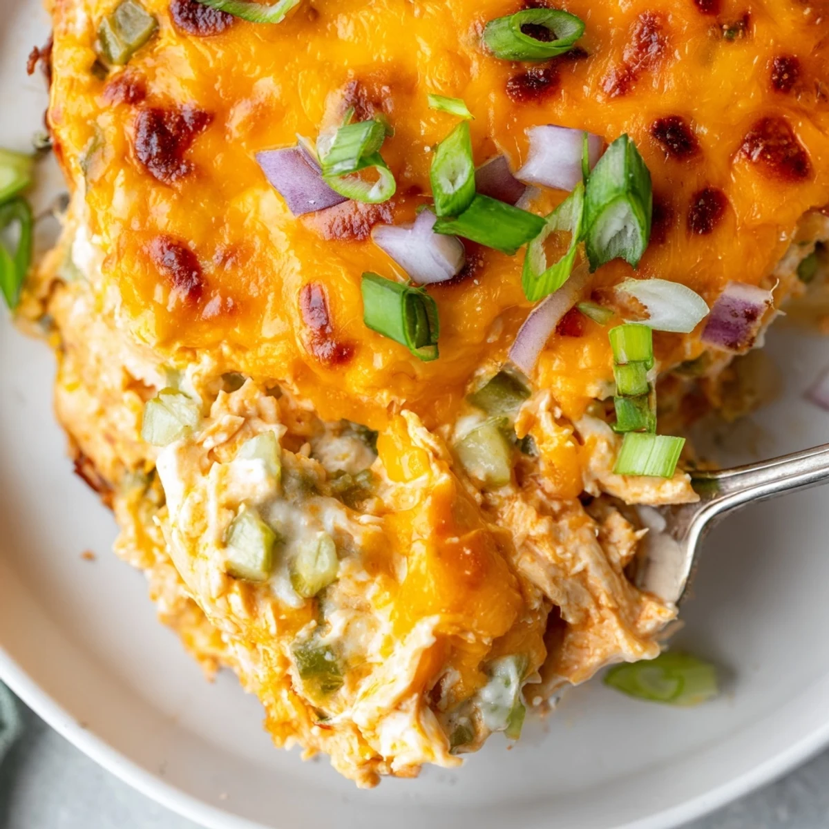 Golden bubbling jalapeno buffalo chicken casserole fresh from the oven, topped with melted cheese