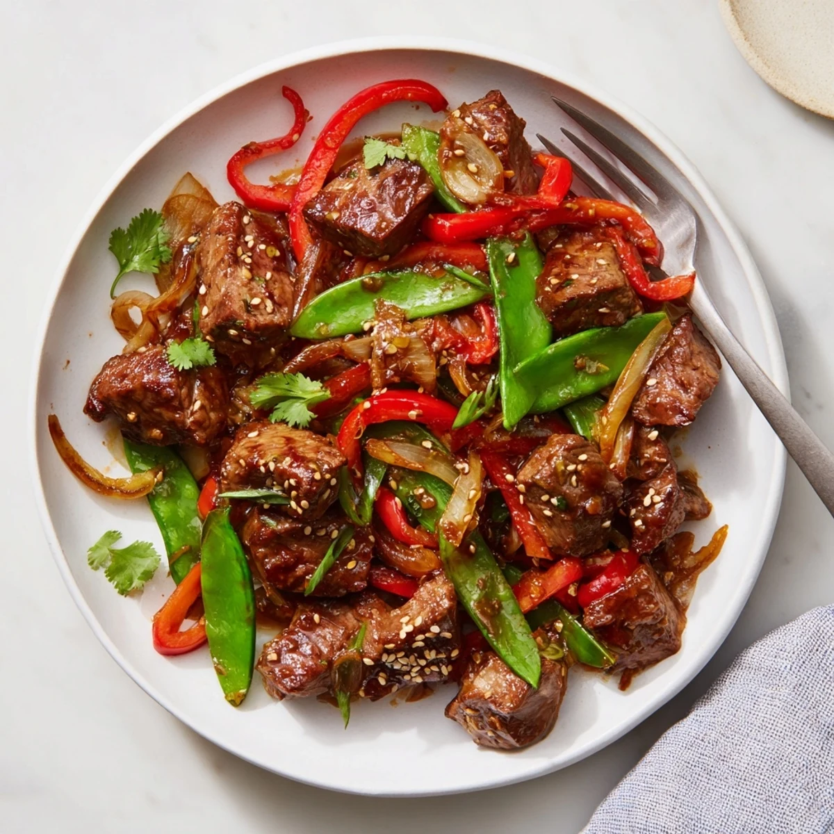 Tender Asian-inspired cube steak glazed in soy ginger sauce with crisp stir-fried vegetables