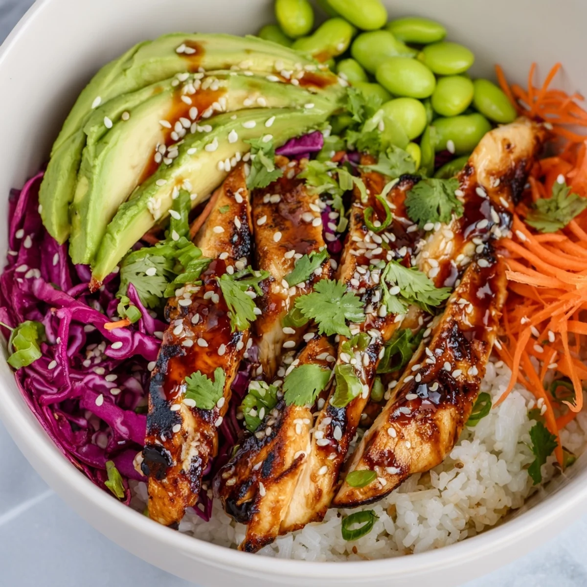 Asian Inspired Chicken Power Bowl drizzled with tangy ginger sauce and toppings
