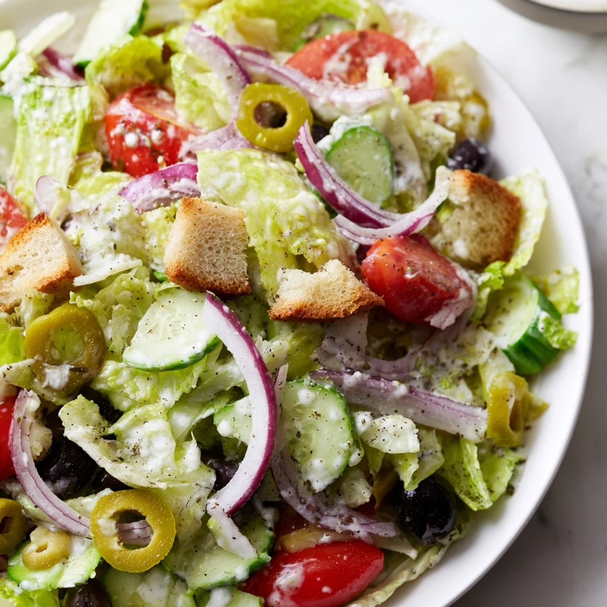 Crisp Olive Garden salad tossed in creamy Italian dressing with crunchy croutons and Parmesan