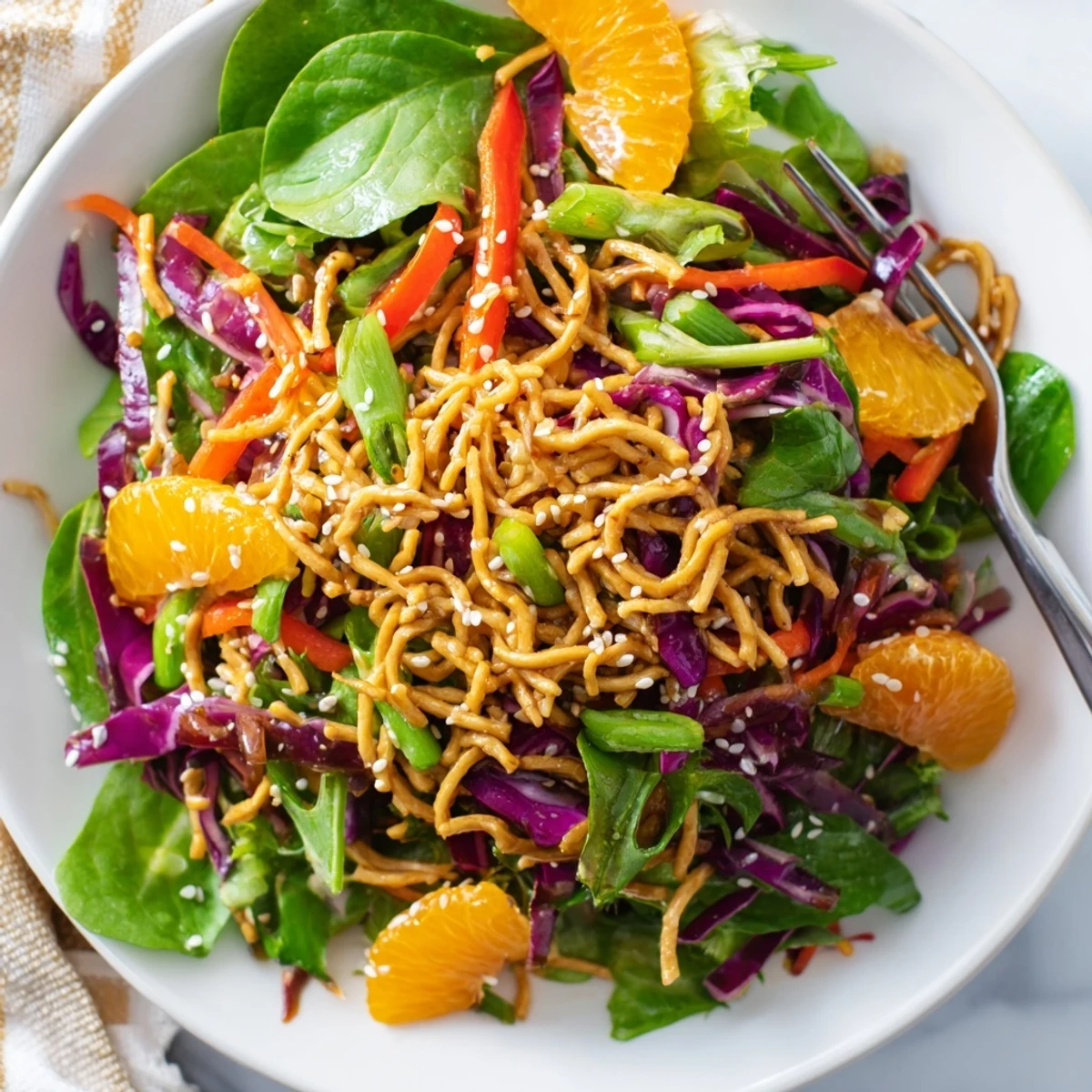 Fresh Mandarin Sesame Crunch Salad in a bowl with shredded cabbage and sweet mandarins