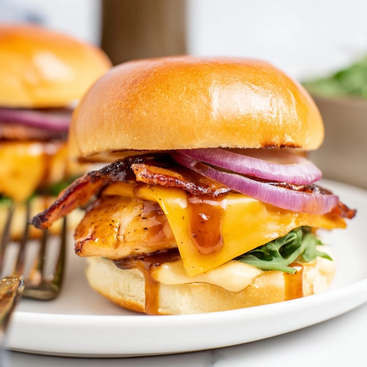 Crispy bacon and juicy maple glazed chicken sliders served on buttery golden slider buns