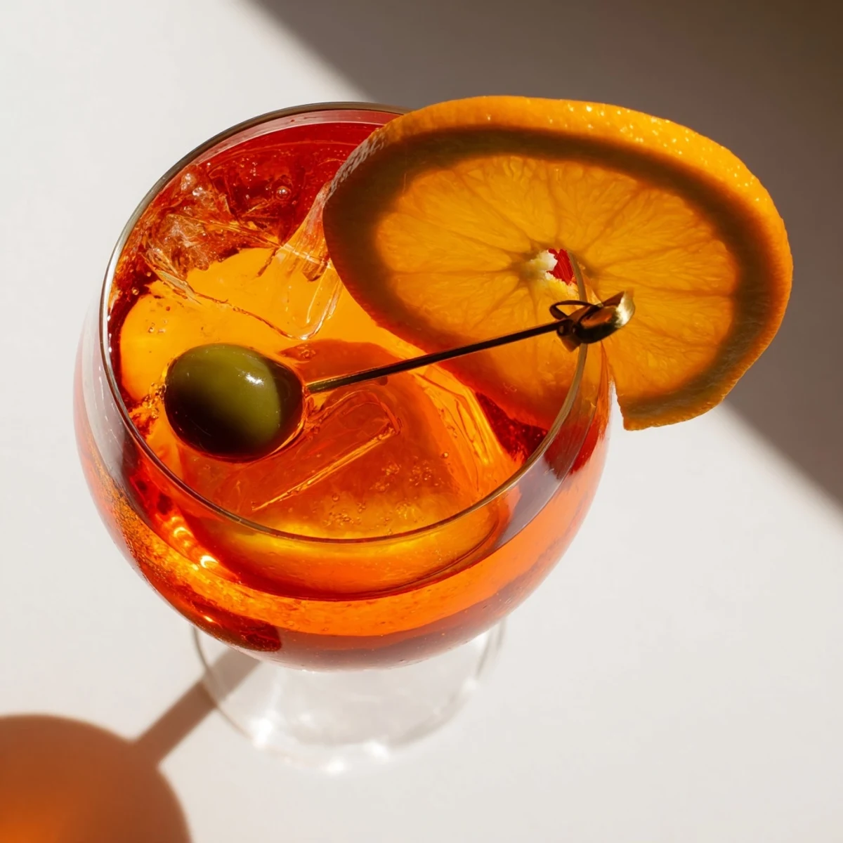 Vibrant orange Spritz cocktail garnished with a fresh slice in a wine glass  
