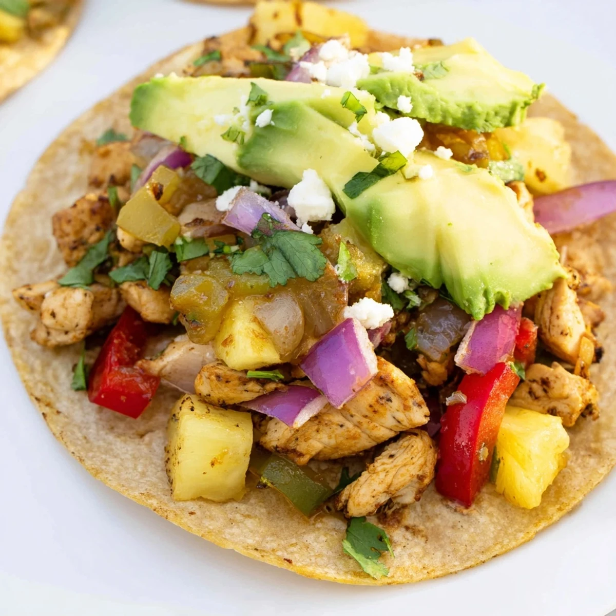 Warm tortillas stuffed with savory chicken and sweet pineapple in this colorful one pan taco recipe.