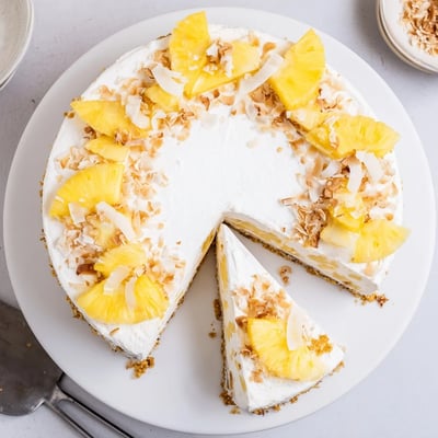No Bake Pineapple Coconut Cream Cake with lush white coconut filling on a graham cracker crust